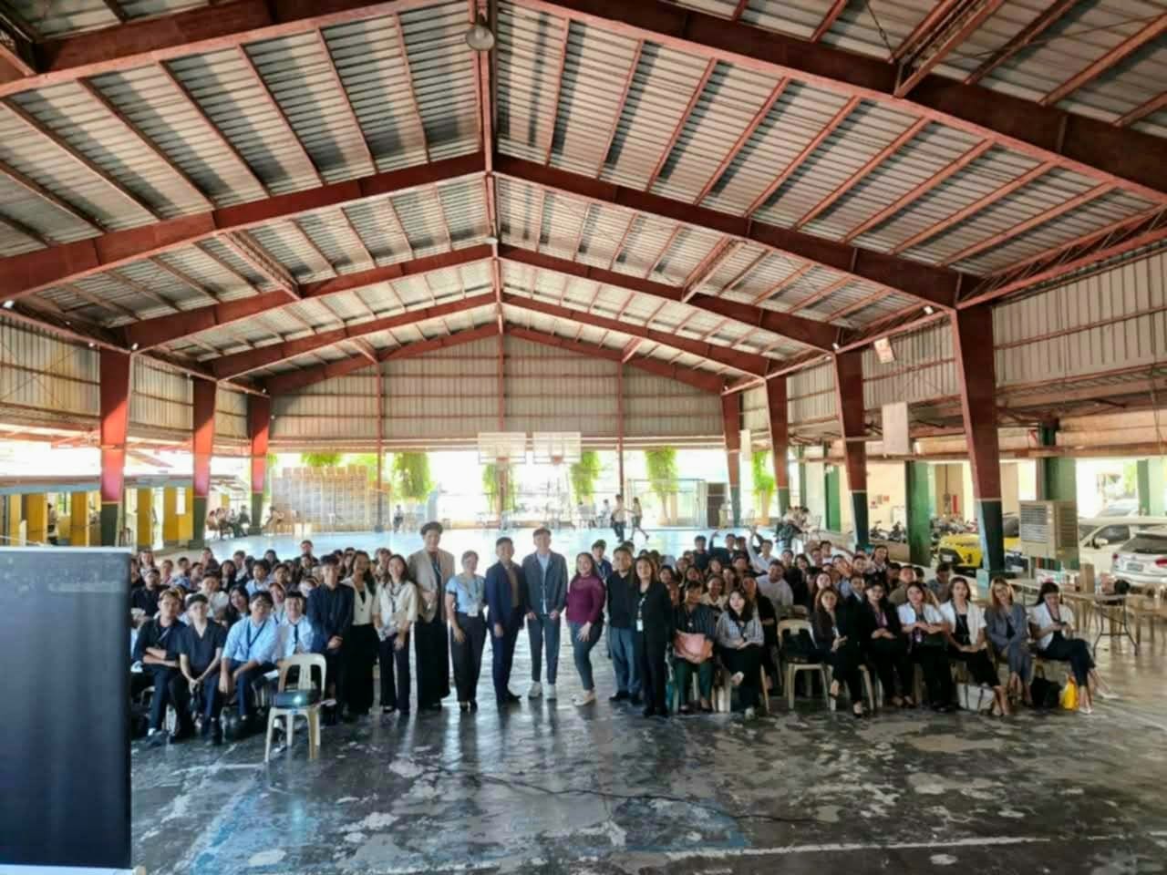 Jayson with BSBA HRM students, faculty, and organizers filling the CvSU Bacoor covered court