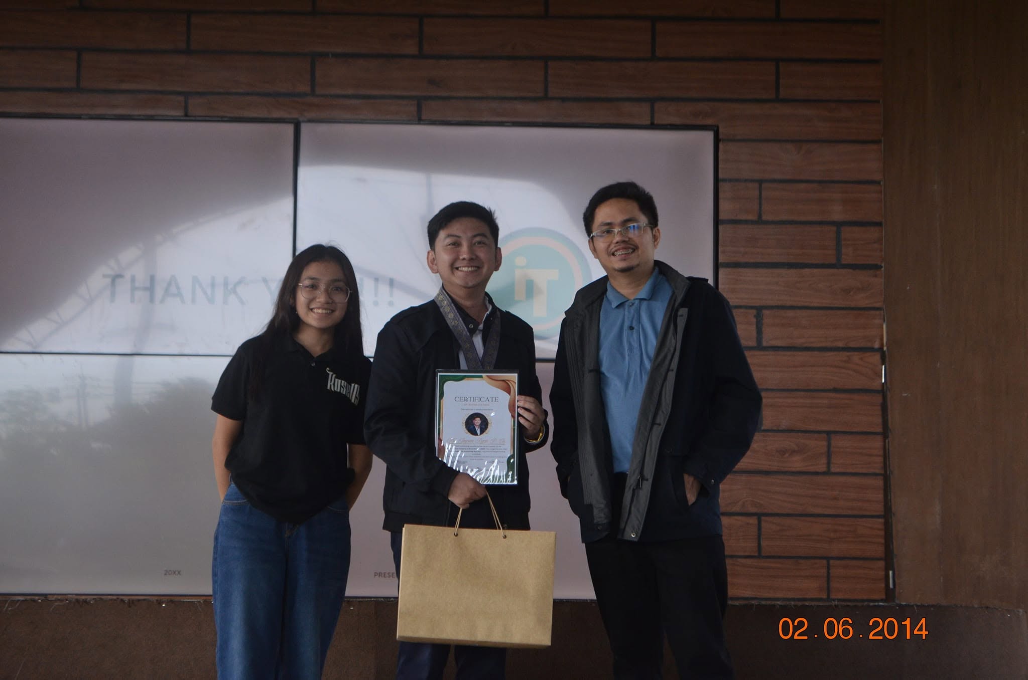 Jayson receiving a certificate of appreciation and token from JPIA DYCI officers