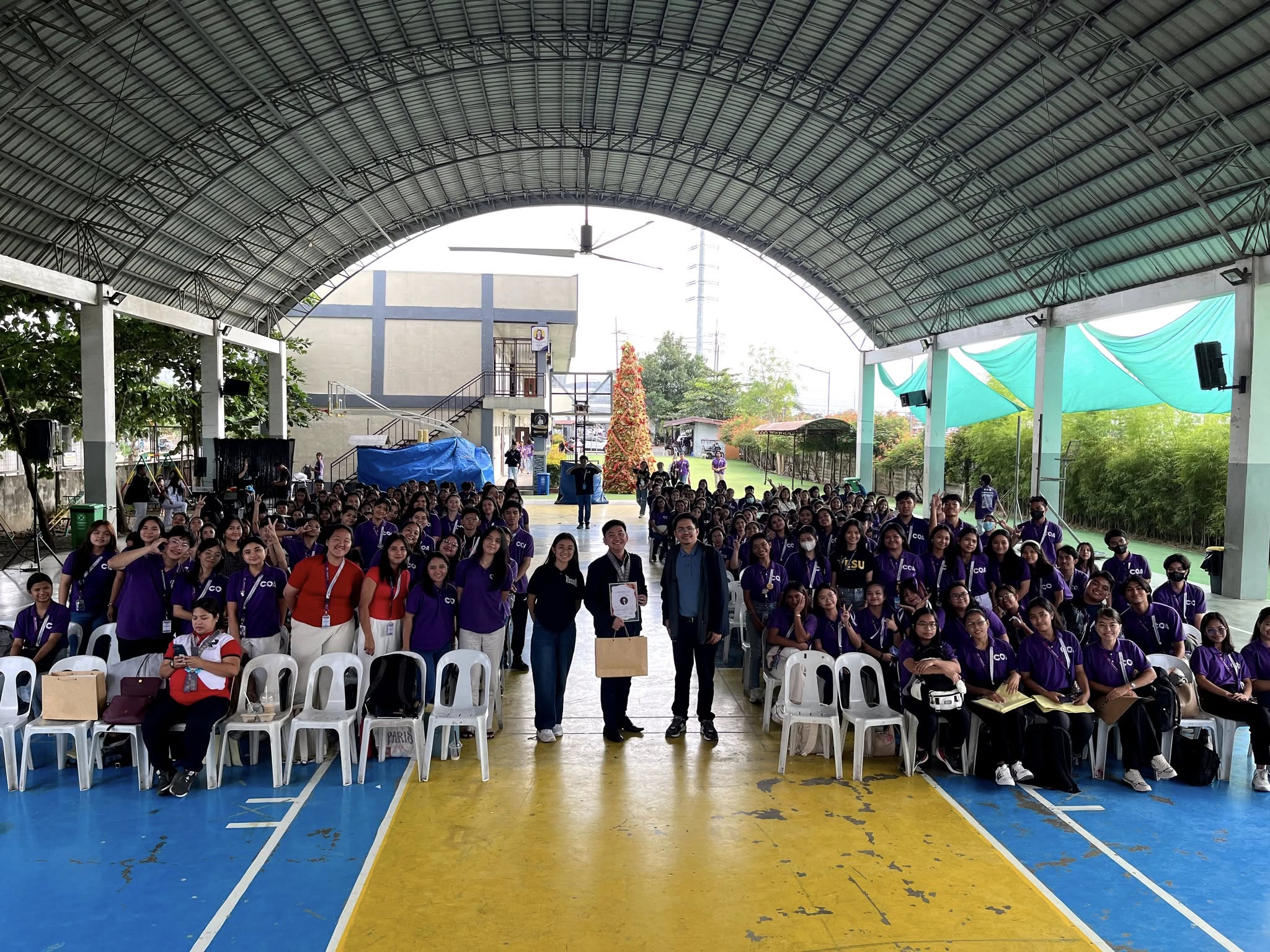 Jayson holding his certificate at the center of a large group photo with JPIA Dr. Yanga’s Colleges accountancy students