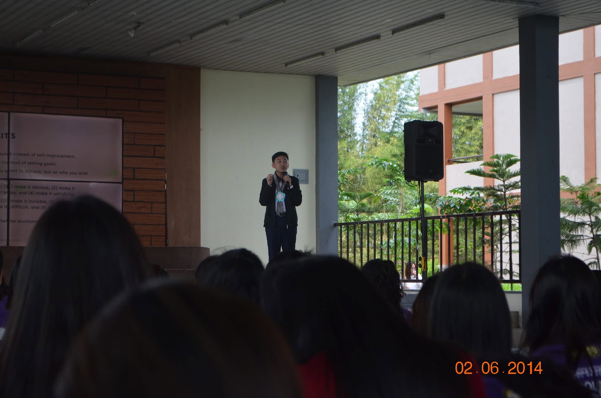 Jayson speaking to the student audience at the covered court