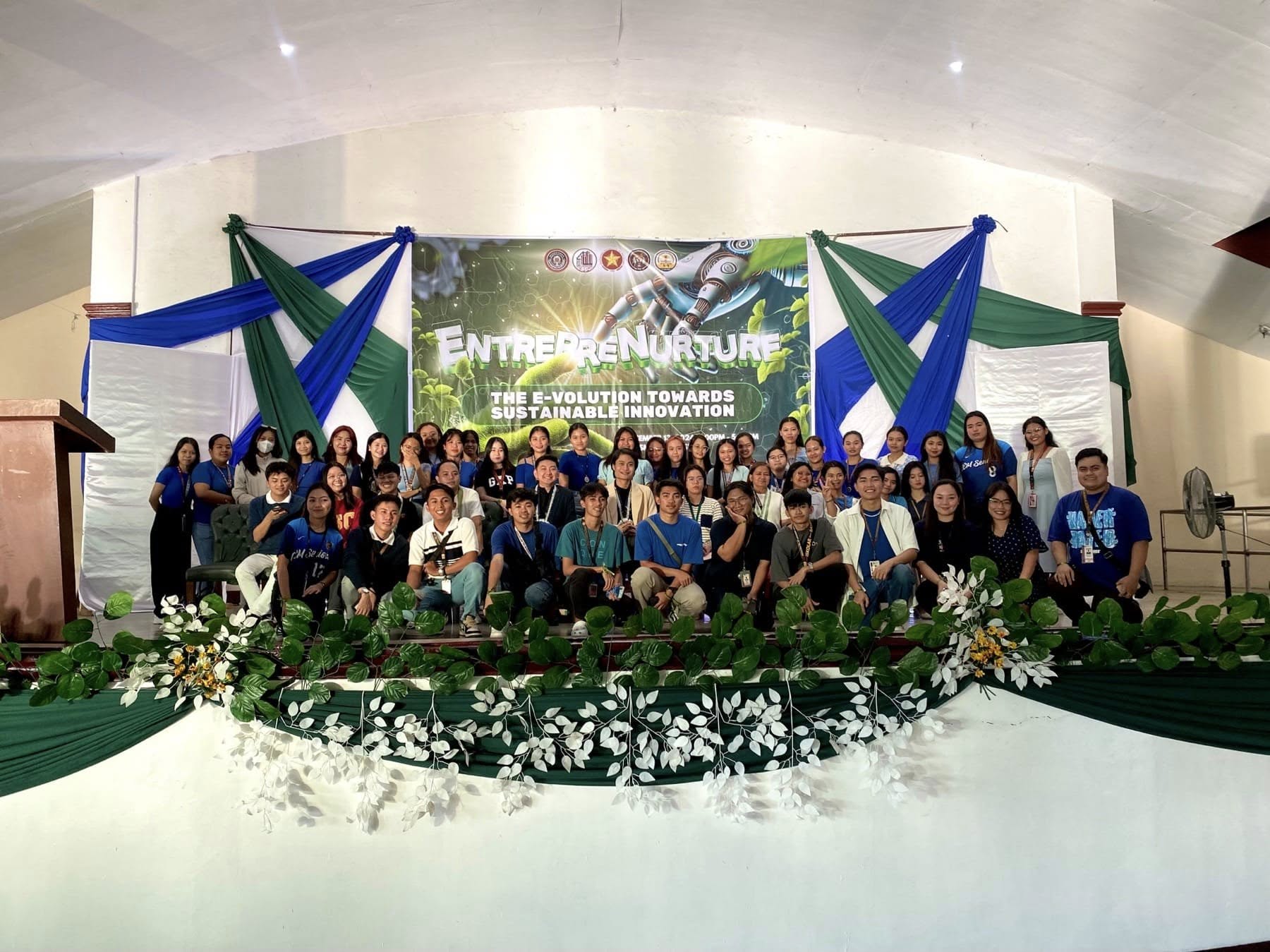 Group photo of Jayson with PUP Santa Maria entrepreneurship students under the EntrepreNurture banner