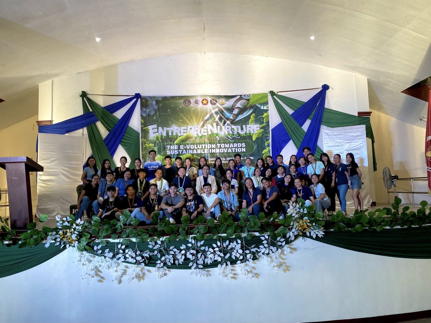 Jayson with the IntegTrust team and BS Entrepreneurship students on the EntrepreNurture stage