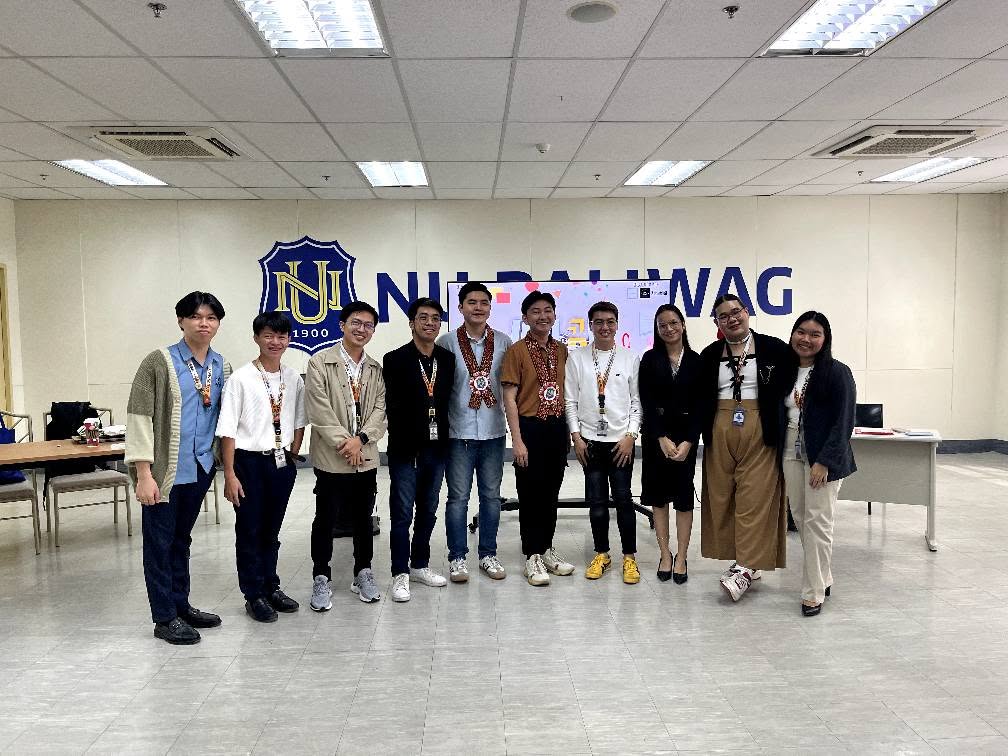 Jayson with the NU Baliwag seminar organizers and facilitators in front of the National University shield