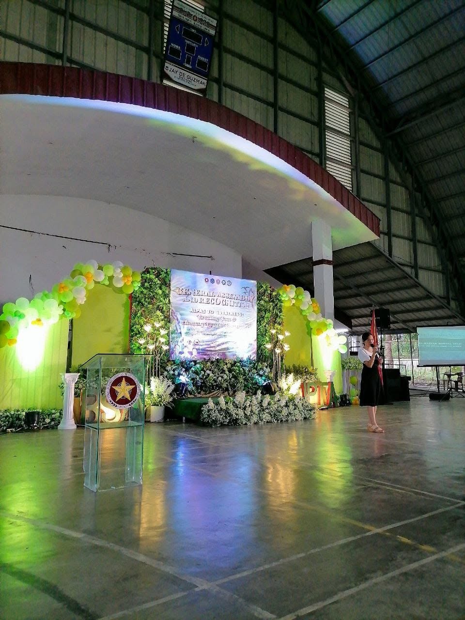 The PUP Santa Maria gymnasium stage decorated with greenery and balloons for the General Assembly and Recognition